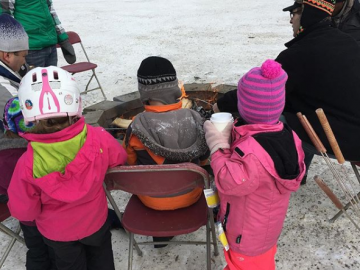Warming by the fire at the Highland Community Family Day Event - Feb 19, 2018